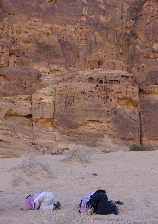 Saudi men praying in the desert, Al Madinah Province, Alula, Saudi Arabia