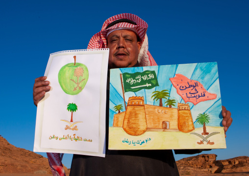 Saudi teacher shwing the drawings of his pupils, Al Madinah Province, Al-Ula, Saudi Arabia