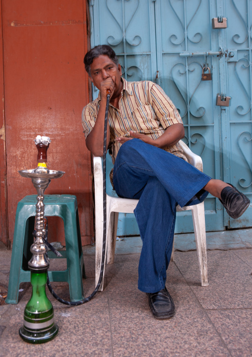 Man smoking water pipe in the street, Hijaz Tihamah region, Jeddah, Saudi Arabia