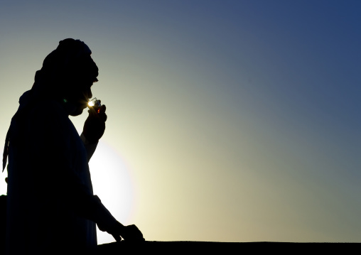 Silhouette of a man drinking tea, Fifa Mountains, Al-Sarawat, Saudi Arabia