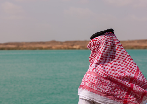 Rear view of a saudi man looking at the red sea, Jizan Region, Farasan island, Saudi Arabia