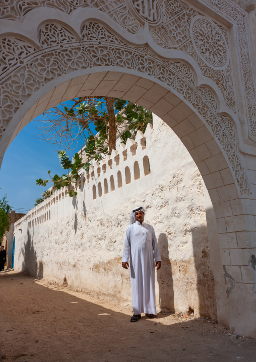Saudi man in al-refae e house gateway decorated with stucco, Jizan Region, Farasan island, Saudi Arabia