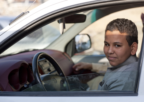 saudi teenage boy driving a car, Najran Province, Najran, Saudi Arabia