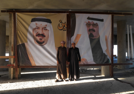 Saudi men in front of giant pictures of the rulers, Fifa Mountains, Al-Sarawat, Saudi Arabia