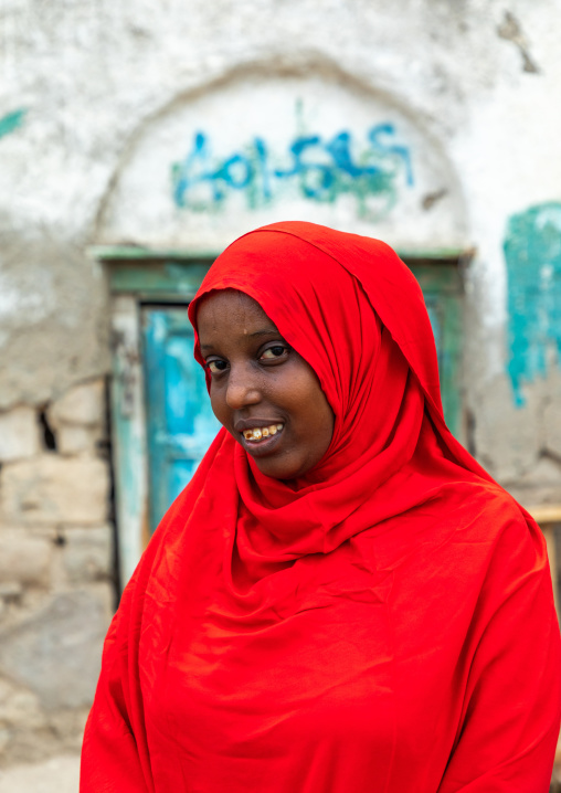 Portrait of a somali woman in red hijab in the streets of the old town, Sahil region, Berbera, Somaliland
