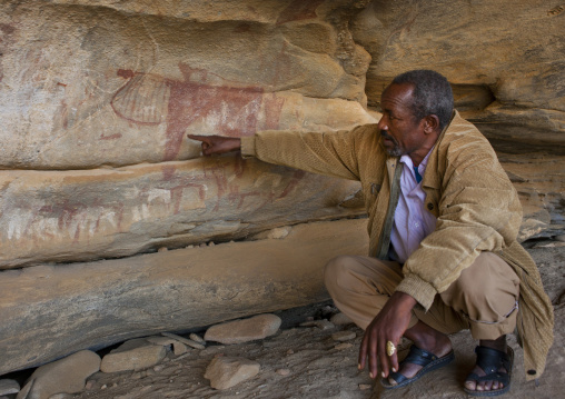 Laas Geel Rock Art Caves, A Squatting Guide Explaining The Meaning Of Paintings, Somaliland