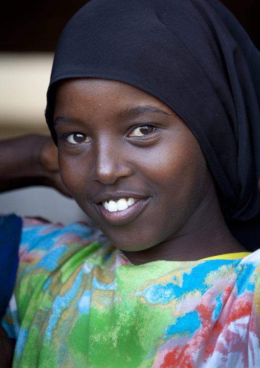 Smiling Portrait Of A Teenage Girl Wearing A Black Hijab And A Colorful Dress, Baligubadle, Somaliland