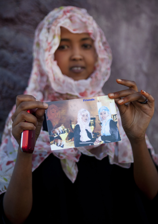 A Teenage Girl Showing Picture Of Her With A Friend, Boorama, Somaliland