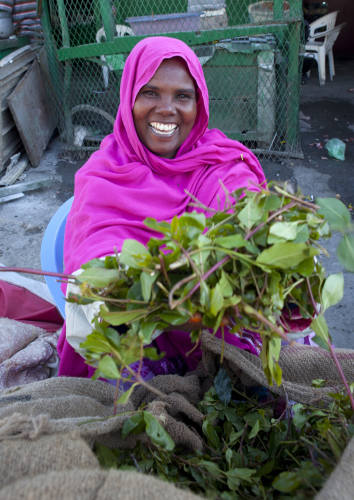 A Woman Wearing A Bright Pink Hijab Selling Khat On The Street, Boorama, Somaliland