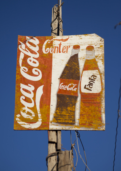Coca Cola  And Fanta Painted Advertisement Stuck To A Wooden Pillar, Boorama, Somaliland