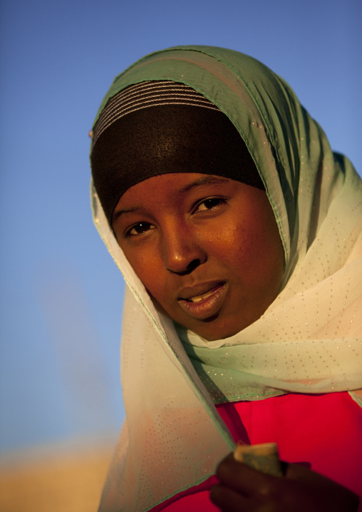 Portrait Of A Cute Teenage Girl Wearing A Green And White Hijab And Holding A Banknote In Her Hands, Boorama, Somaliland