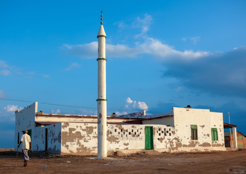 Somali man with in front of a mosque, Awdal region, Zeila, Somaliland
