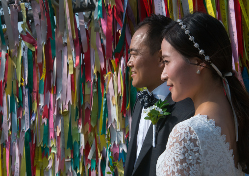 North korean defector joseph park with his south korean fiancee juyeon in front of messages of peace written on ribbons left on dmz, Sudogwon, Paju, South korea