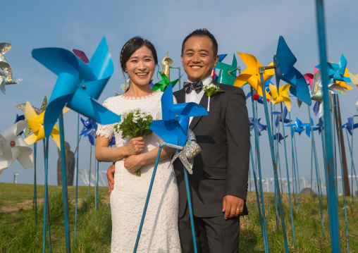 North korean defector joseph park with his south korean fiancee called juyeon in the middle of windmills in imjingak park, Sudogwon, Paju, South korea
