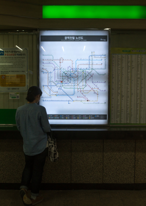Korean woman looking at subway station map, National capital area, Seoul, South korea
