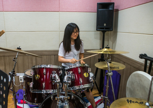 North korean teen defector in yeo-mung alternative school playing drums, National capital area, Seoul, South korea