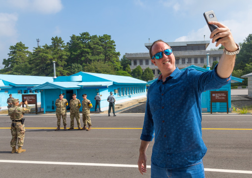 Tourist taking a selfie in the joint security area on the border between the two Korea, North Hwanghae Province, Panmunjom, South Korea