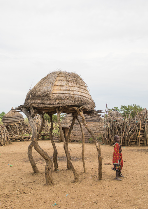 Toposa tribe girl standing near a granary in a village, Namorunyang State, Kapoeta, South Sudan