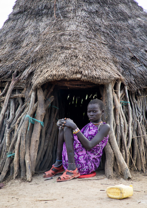 Toposa tribe woman sit at the entrance of her hut, Namorunyang State, Kapoeta, South Sudan