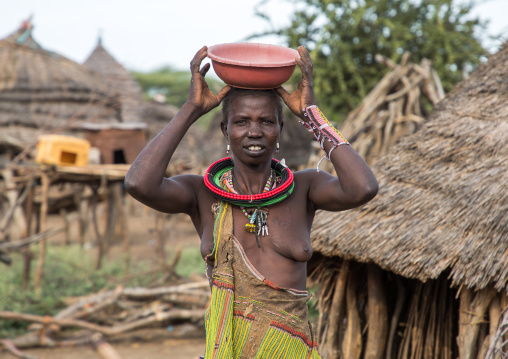 Portrait of a Toposa tribe woman carrying a pot on her head, Namorunyang State, Kapoeta, South Sudan