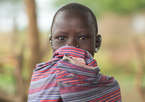 Portrait of a Toposa girl covering her mouth, Namorunyang State, Kapoeta, South Sudan