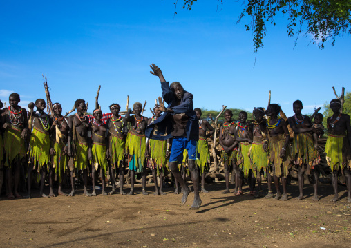 Toposa tribe man dancing in front of women during a ceremony, Namorunyang State, Kapoeta, South Sudan