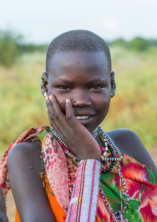 Portrait of a Toposa tribe young woman wearing beaded necklace, Namorunyang State, Kapoeta, South Sudan