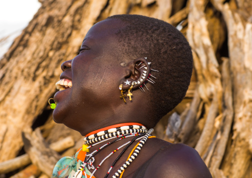 Portrait of a laughing Toposa tribe woman with earrings, Namorunyang State, Kapoeta, South Sudan