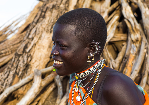 Portrait of a smiling Toposa tribe woman with earrings, Namorunyang State, Kapoeta, South Sudan