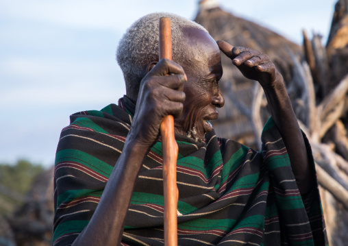 Toposa tribe senior man with a wood stick looking away, Namorunyang State, Kapoeta, South Sudan