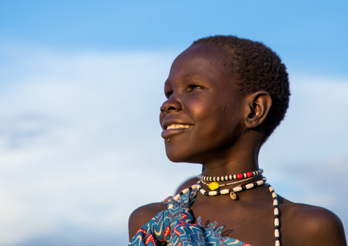 Portrait of a smiling Toposa girl looking away, Namorunyang State, Kapoeta, South Sudan