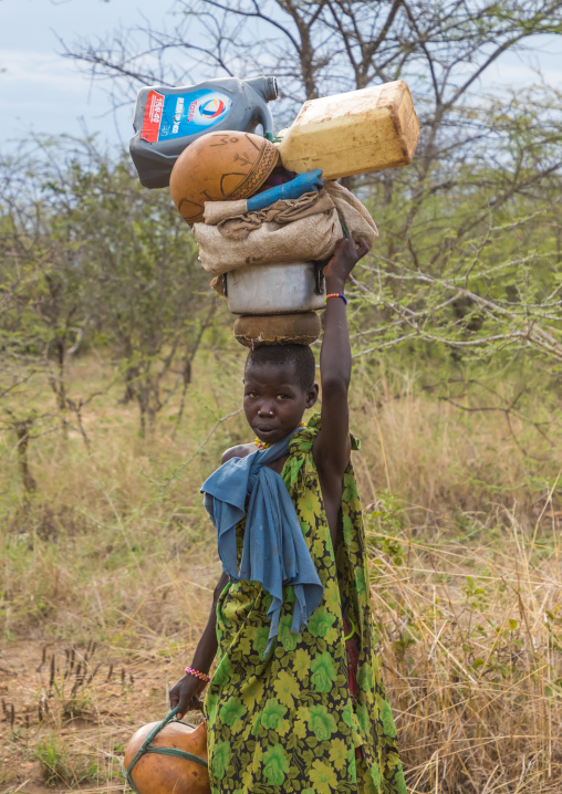 Larim tribe woman carrying heavy stuff on her head, Boya Mountains, Imatong, South Sudan