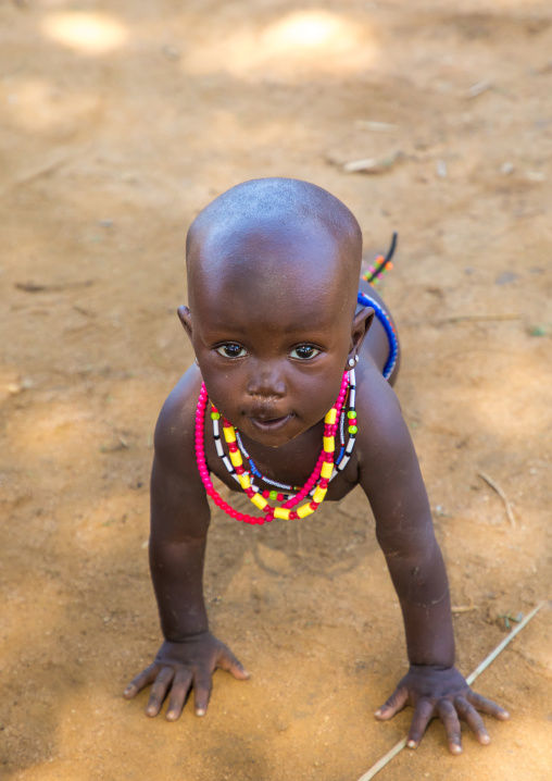 Larim tribe baby girl on all fours
, Boya Mountains, Imatong, South Sudan