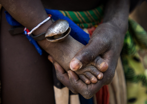 Larim tribe mother hand touching the foot of her baby, Boya Mountains, Imatong, South Sudan