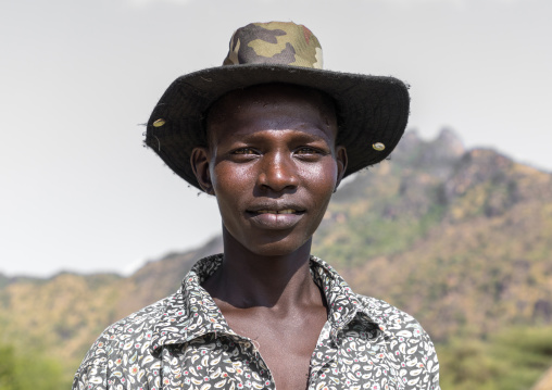 Portrait of a Larim tribe young man with a hat, Boya Mountains, Imatong, South Sudan