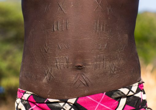 Portrait of a Larim tribe woman with scarifications on her belly, Boya Mountains, Imatong, South Sudan