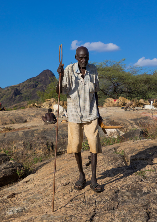 Old Larim tribe man walking with a traditional stick, Boya Mountains, Imatong, South Sudan
