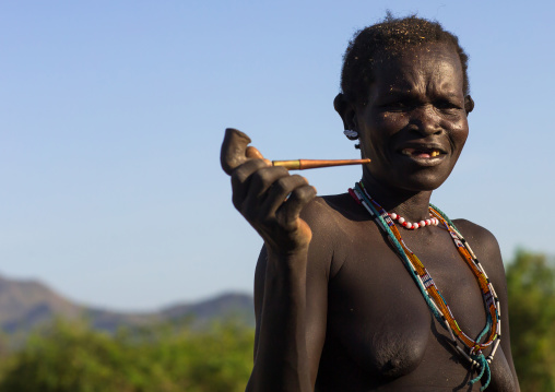 Larim senior tribe woman smoking pipe, Boya Mountains, Imatong, South Sudan