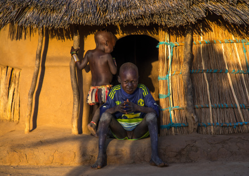Children at the entrance of a Larim tribe traditional house, Boya Mountains, Imatong, South Sudan