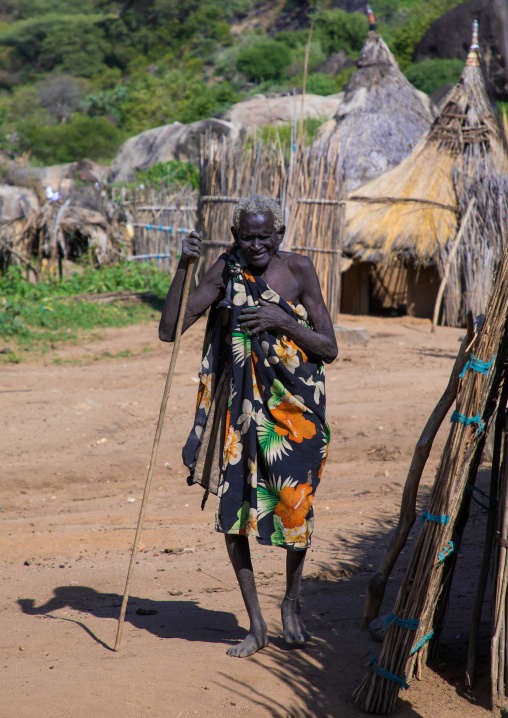 Old woman passing in a Larim tribe traditional village, Boya Mountains, Imatong, South Sudan