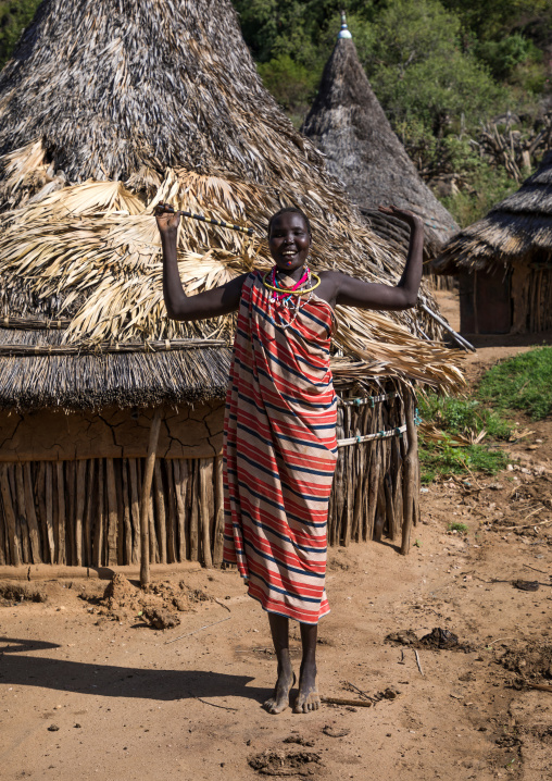 Larim tribe woman dancing with a traditional stick, Boya Mountains, Imatong, South Sudan