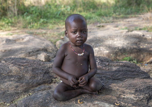 Larim tribe boy sit on a rock, Boya Mountains, Imatong, South Sudan