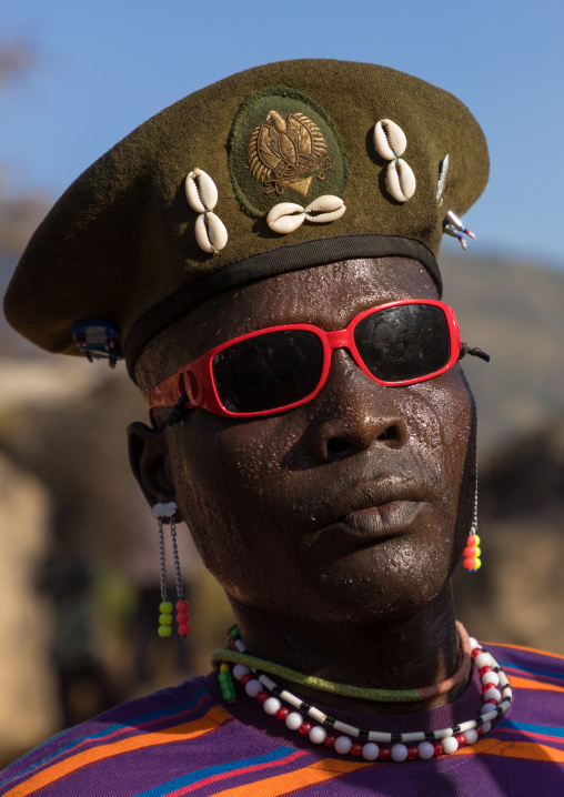 Larim tribe man with sunglasses during a wedding ceremony, Boya Mountains, Imatong, South Sudan