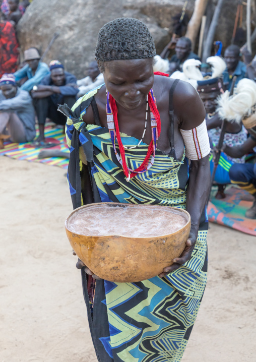Larim tribe woman carrying alcohol in a calabash during a wedding ceremony, Boya Mountains, Imatong, South Sudan