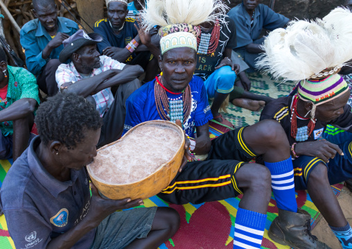 Larim tribe men drinking alcohol in a calabash during a wedding ceremony, Boya Mountains, Imatong, South Sudan