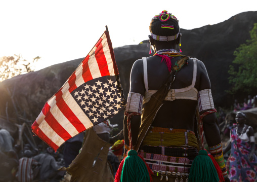 Larim tribe woman with an american flag during a wedding celebration, Boya Mountains, Imatong, South Sudan