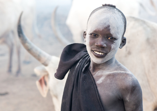 Smiling Mundari tribe boy covered in ash to repel flies and mosquitoes in a cattle camp, Central Equatoria, Terekeka, South Sudan