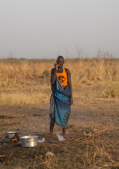 Mundari tribe woman using a wooden toothbrush, Central Equatoria, Terekeka, South Sudan