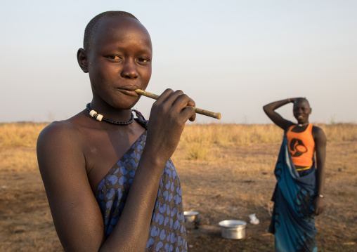 Mundari tribe woman using a wooden toothbrush, Central Equatoria, Terekeka, South Sudan