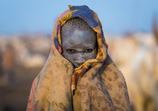 A Mundari tribe boy wrapped in blanket to fight the cold in a cattle camp, Central Equatoria, Terekeka, South Sudan